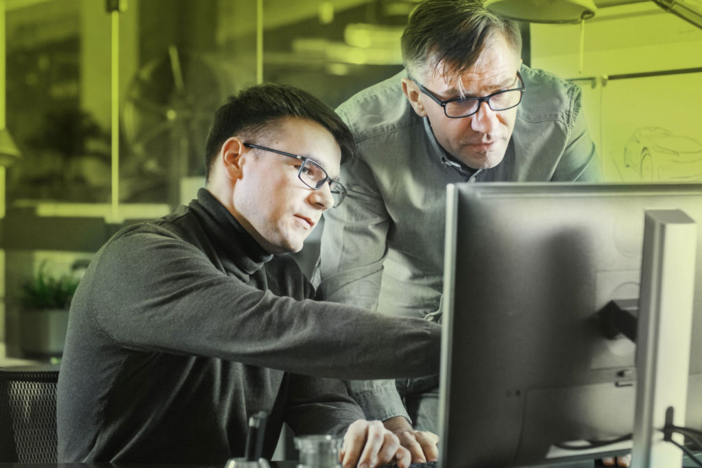 symbolic image for planning and consulting green background two men stand at the screen and discuss what is to be seen there